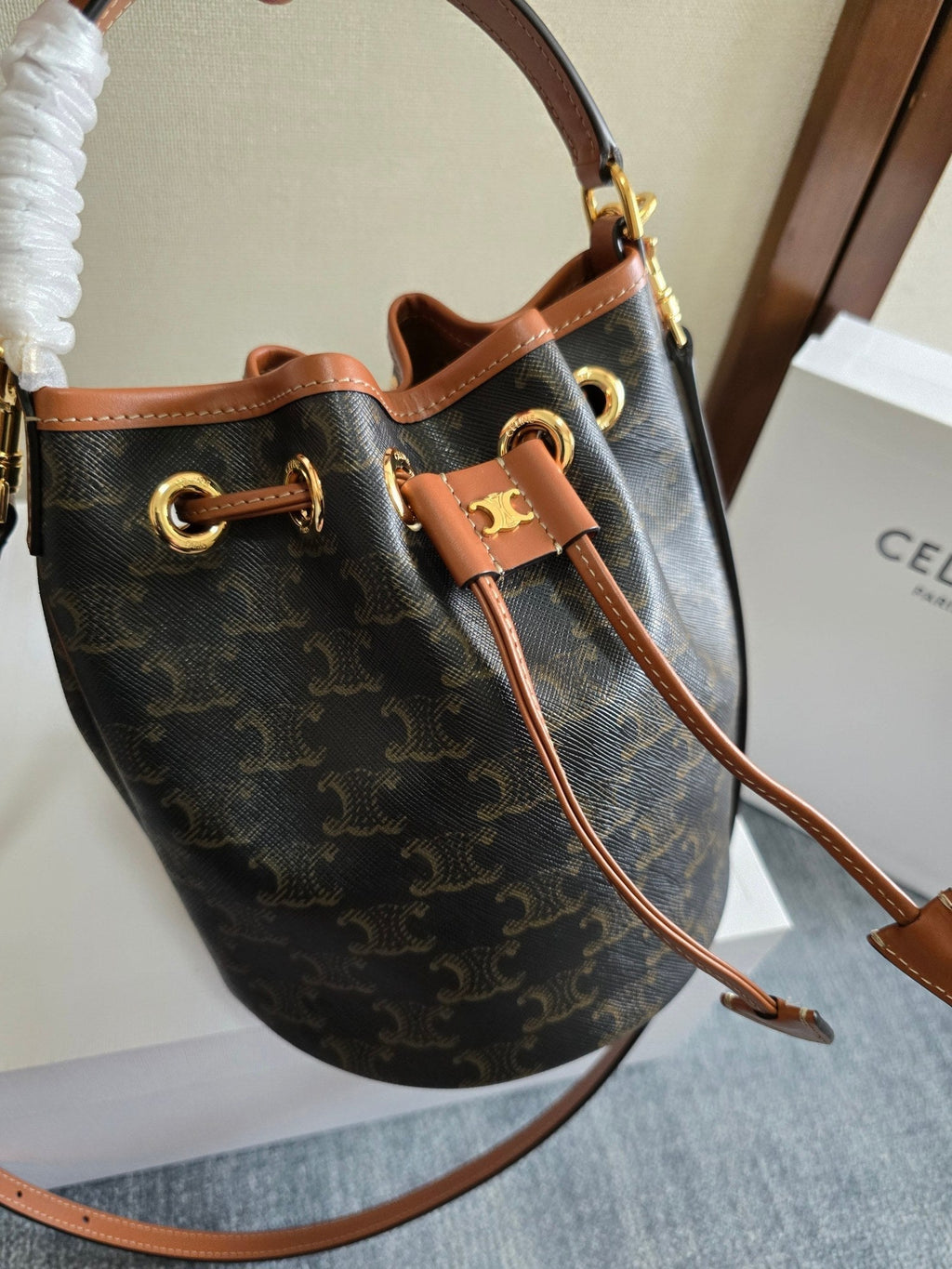 CLARA BAG 19 IN BLACK TRIOMPHE CANVAS AND BROWN CALFSKIN TRIM