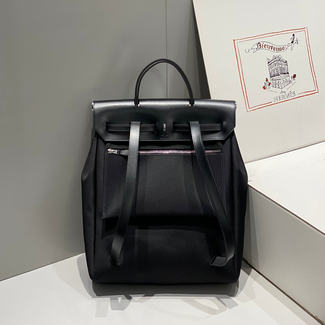 HERBAG A DOS ZIP RETOURNE BACKPACK 29 IN BLACK CANVAS AND CALFSKIN