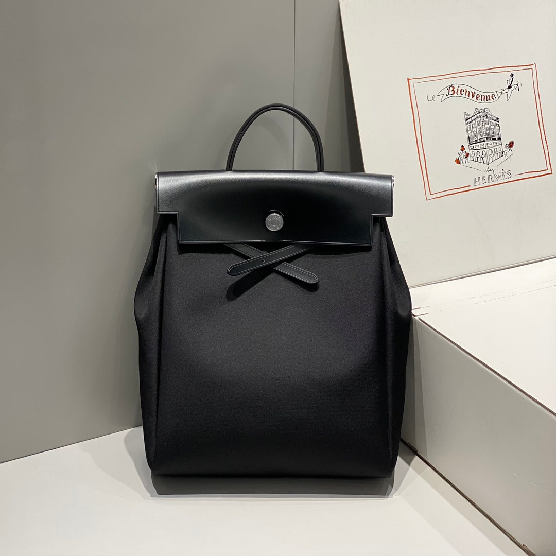 HERBAG A DOS ZIP RETOURNE BACKPACK 29 IN BLACK CANVAS AND CALFSKIN